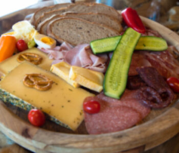 Typical traditional European snack with sausage, cheese and bread. Appetizingly prepared on a rustic board.