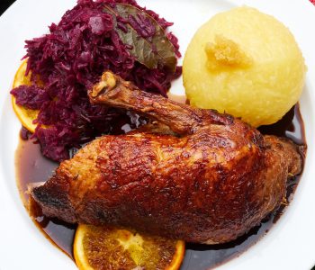 Duck fried in the oven with potato dumplings blue cabbage and sauce nice and crispy